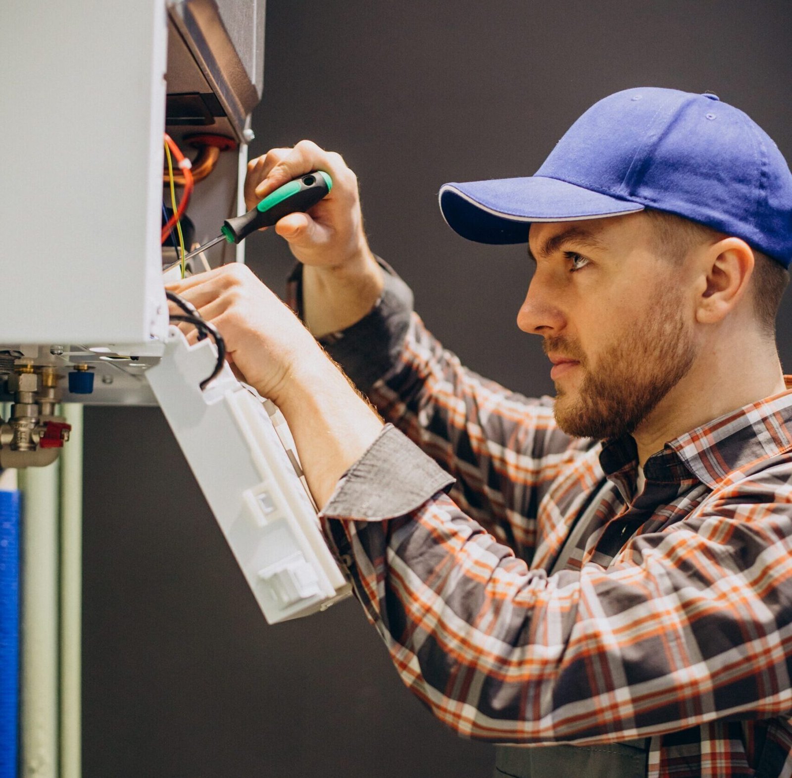 Service man adjusting house heating system